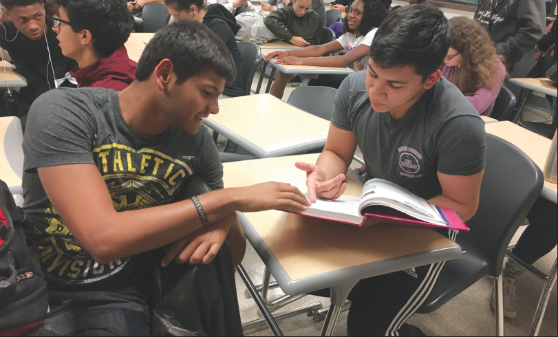 Hasan Ghalib, right, helps fellow student Het Patel with homework.