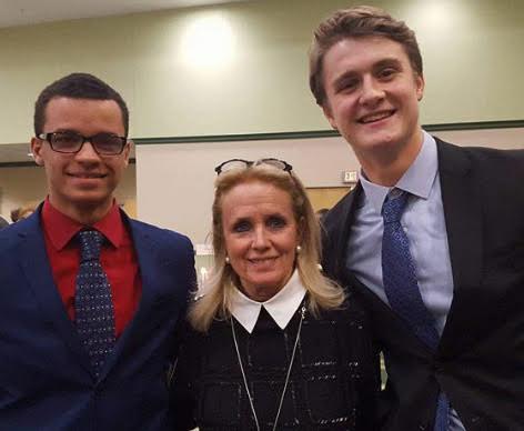 Kane (left) with fellow senior Henry Taylor and U.S. Rep. Debbie Dingell (D-Michigan).