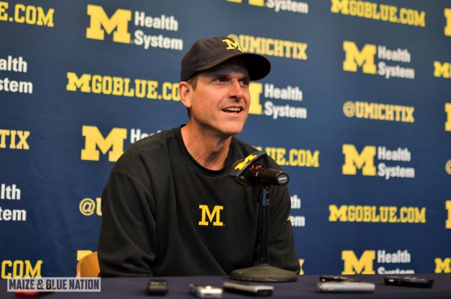 Jim Harbaugh speaks at a press conference (Wikimedia Commons)
