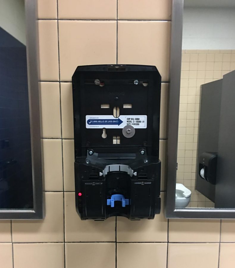 A soap dispenser in a womens bathroom was removed, along with the top.