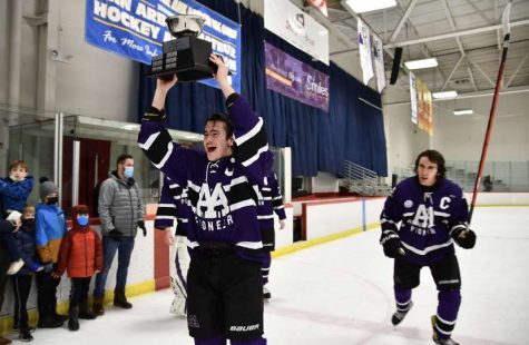 Pioneer captain Francis Roderique lifts the Jilek Cup following a 6-4 victory against Skyline.