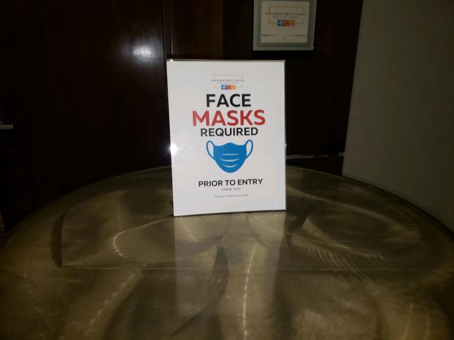 The Ann Arbor Board of Education posts its own mandatory masking signs in the Sheraton Hotel meeting room because the hotel does not have a mandatory masking policy.