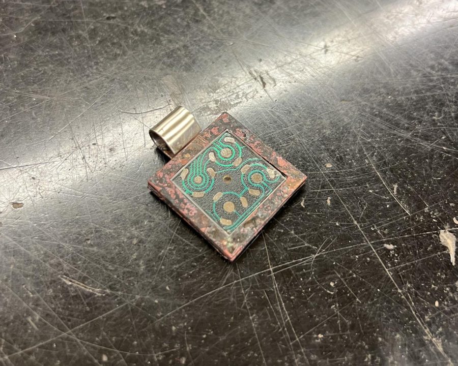 A piece of jewelry integrated with a circuit board.