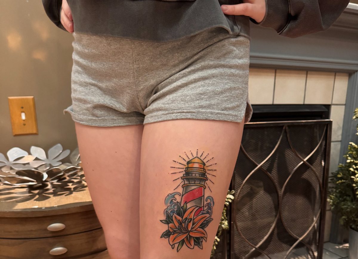 Senior Carissa Frayer displays a tattoo she recently got on her upper thigh.