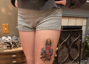 Senior Carissa Frayer displays a tattoo she recently got on her upper thigh.